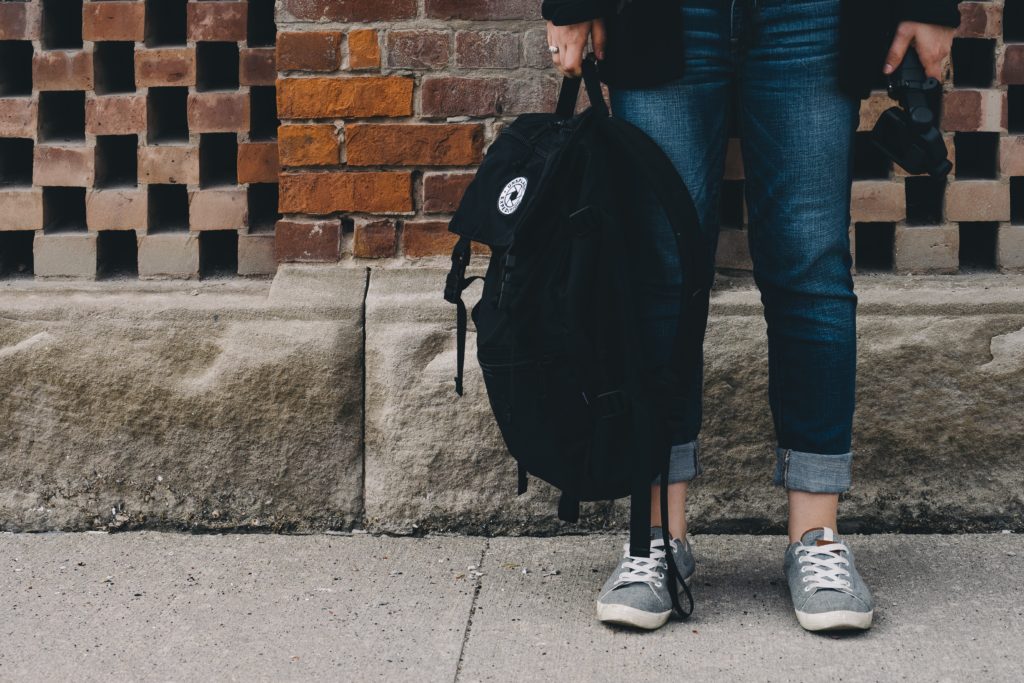 teen holding backpack worried about grades