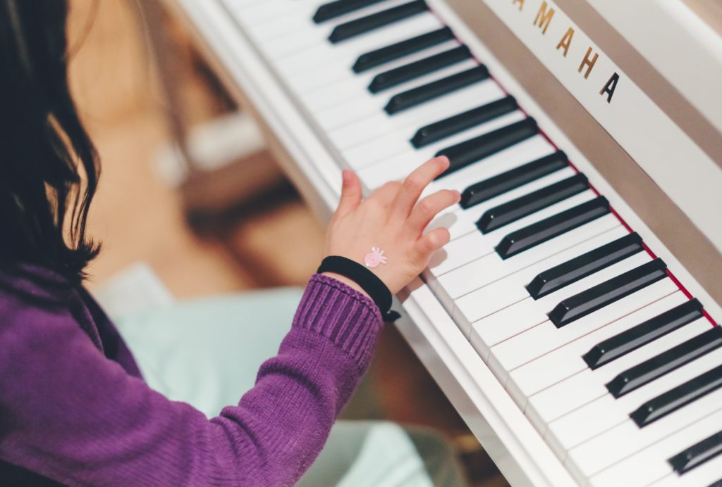 child using piano to cultivate their gifts