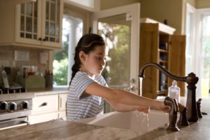 child washing hands to stop the spread of germs